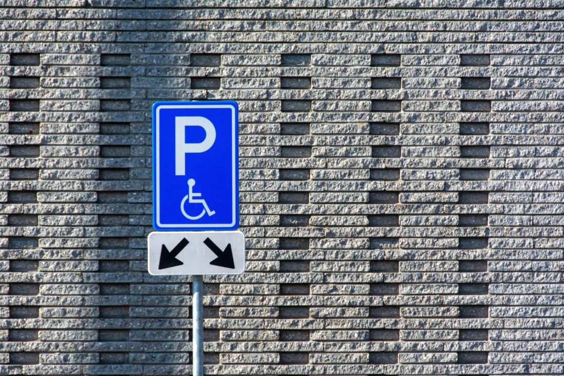 Disabled parking space marked with blue and white symbols.